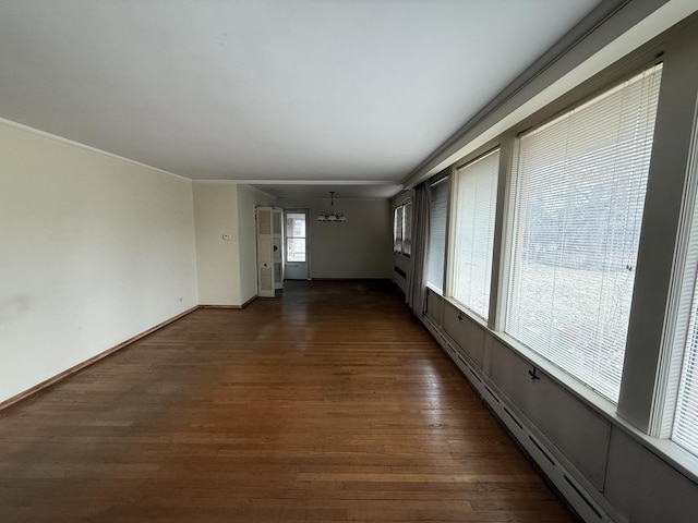 1850 Garland Ave, Highland Park, IL 60035 - spare room featuring a chandelier, dark wood-style floors, baseboards, and a baseboard heating unit
