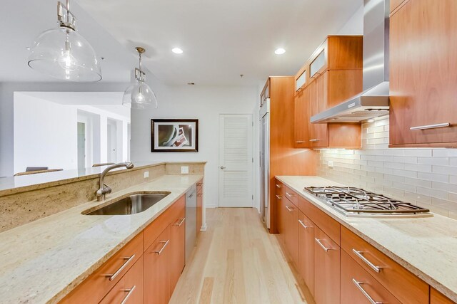 500 W Superior St Unit 612, Chicago, IL 60654 - kitchen with a sink, appliances with stainless steel finishes, wall chimney exhaust hood, light stone countertops, and light wood-type flooring