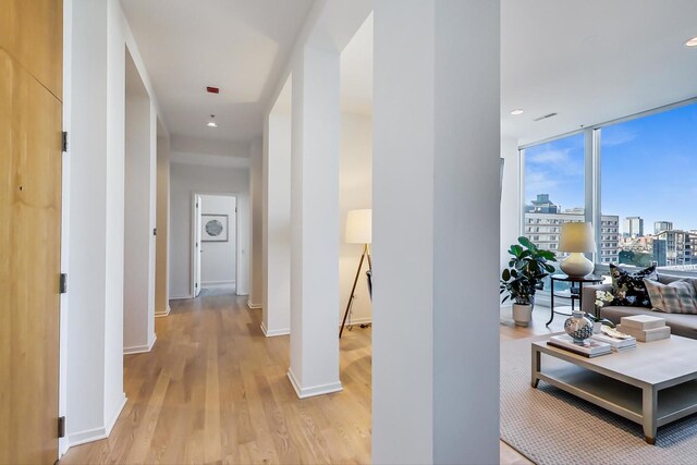 500 W Superior St Unit 612, Chicago, IL 60654 - corridor with light wood-style floors, a wall of windows, baseboards, a view of city, and recessed lighting