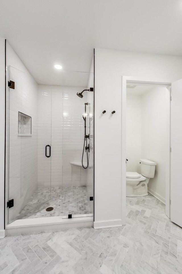 500 W Superior St Unit 612, Chicago, IL 60654 - bathroom featuring toilet, a stall shower, baseboards, and recessed lighting