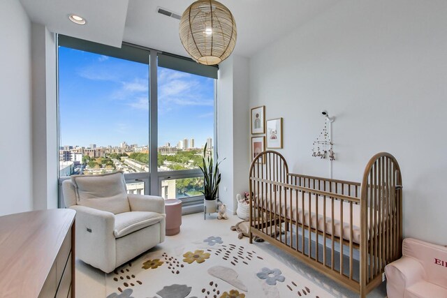 500 W Superior St Unit 612, Chicago, IL 60654 - carpeted bedroom with a view of city, a nursery area, and a wall of windows