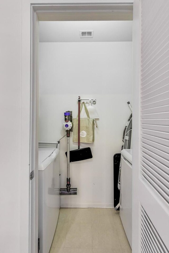 500 W Superior St Unit 612, Chicago, IL 60654 - laundry room featuring separate washer and dryer and tile patterned floors