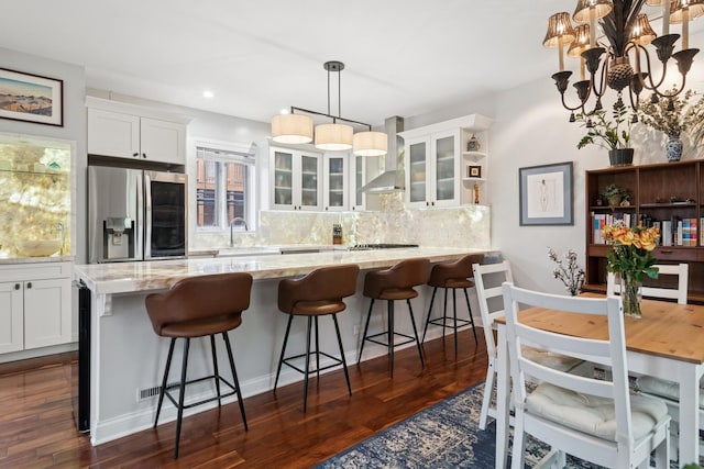 1012 S Loomis St Unit F, Chicago, IL 60607 - kitchen with stainless steel refrigerator with ice dispenser, wall chimney exhaust hood, white cabinetry, decorative backsplash, and recessed lighting