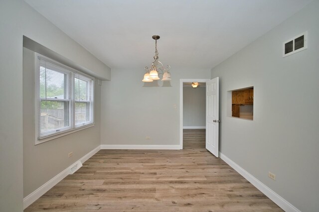 7410 162nd St, Tinley Park, IL 60477 - unfurnished dining area with light wood finished floors, baseboards, a chandelier, and a ceiling fan