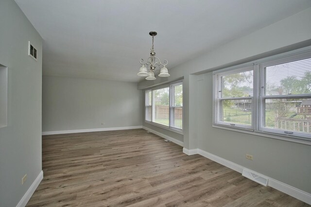 7410 162nd St, Tinley Park, IL 60477 - unfurnished dining area featuring a chandelier, baseboards, and wood finished floors