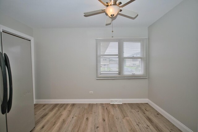 7410 162nd St, Tinley Park, IL 60477 - spare room featuring ceiling fan, light wood finished floors, and baseboards