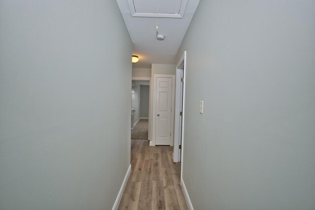 7410 162nd St, Tinley Park, IL 60477 - corridor featuring attic access, light wood finished floors, and baseboards