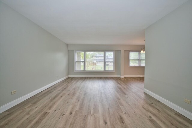 7410 162nd St, Tinley Park, IL 60477 - spare room featuring wood finished floors, baseboards, and a chandelier