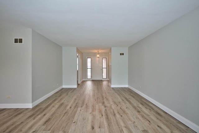 7410 162nd St, Tinley Park, IL 60477 - unfurnished living room featuring light wood-style floors and baseboards