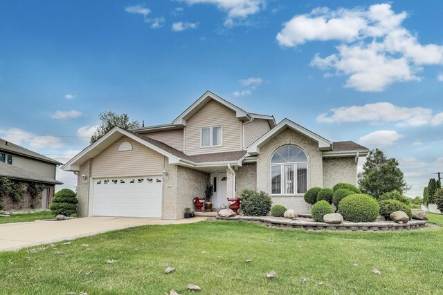 1347 Rainbow Cir, Manteno, IL 60950 - traditional home featuring a front lawn, driveway, an attached garage, and brick siding