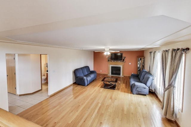1347 Rainbow Cir, Manteno, IL 60950 - living area with a ceiling fan, a fireplace, wood finished floors, and baseboards