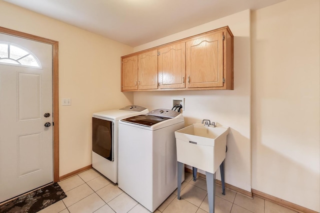 1347 Rainbow Cir, Manteno, IL 60950 - laundry room featuring washer and clothes dryer, cabinet space, baseboards, and light tile patterned floors