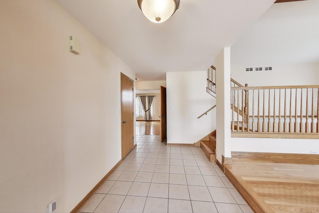 1347 Rainbow Cir, Manteno, IL 60950 - hall with light tile patterned floors, stairway, and baseboards