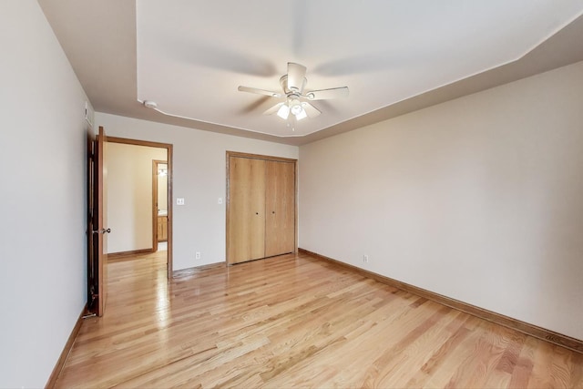 1347 Rainbow Cir, Manteno, IL 60950 - unfurnished bedroom with light wood-type flooring, a closet, baseboards, and a ceiling fan