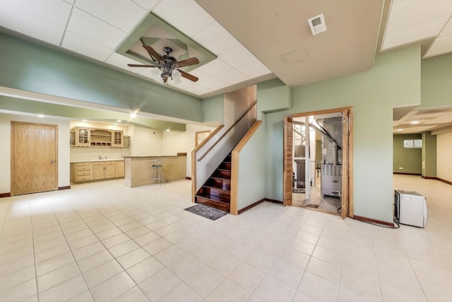 1347 Rainbow Cir, Manteno, IL 60950 - unfurnished living room featuring stairway, baseboards, a ceiling fan, and light tile patterned flooring