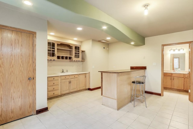 1347 Rainbow Cir, Manteno, IL 60950 - kitchen with a breakfast bar, recessed lighting, open shelves, baseboards, and light brown cabinetry