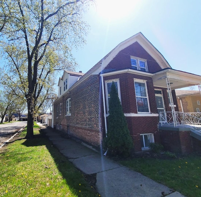 6801 S Oakley Ave, Chicago, IL 60636 - view of side of property with brick siding, a porch, and a yard