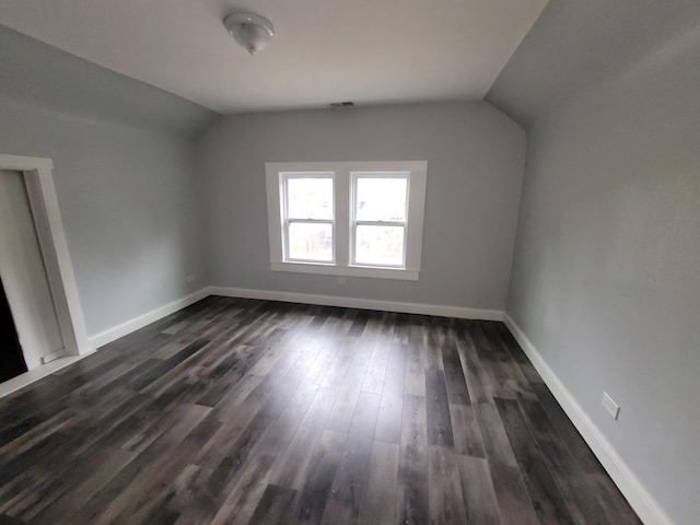 6801 S Oakley Ave, Chicago, IL 60636 - bonus room with lofted ceiling, dark wood-style flooring, and baseboards
