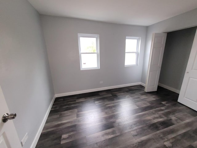 6801 S Oakley Ave, Chicago, IL 60636 - unfurnished bedroom featuring baseboards and dark wood-style flooring