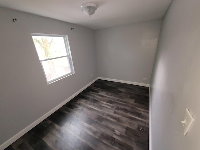 6801 S Oakley Ave, Chicago, IL 60636 - unfurnished room with baseboards and dark wood-style floors