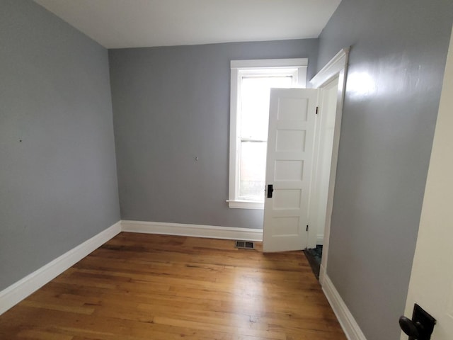 6801 S Oakley Ave, Chicago, IL 60636 - empty room with wood finished floors, baseboards, and healthy amount of natural light