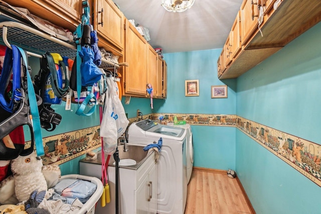 21705 W Knollwood Ct, Plainfield, IL 60544 - laundry area featuring washer and dryer, cabinet space, and light wood-style floors