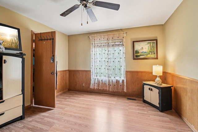 21705 W Knollwood Ct, Plainfield, IL 60544 - spare room featuring wainscoting, wood finished floors, wooden walls, and ceiling fan