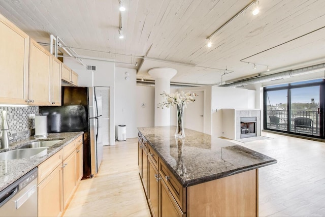 1525 S Sangamon St Unit 312, Chicago, IL 60608 - kitchen with rail lighting, dishwasher, a sink, light wood-style floors, and tasteful backsplash