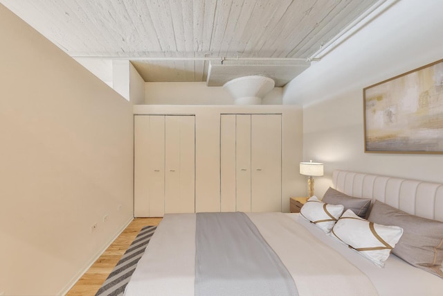 1525 S Sangamon St Unit 312, Chicago, IL 60608 - bedroom featuring two closets, wood finished floors, and track lighting