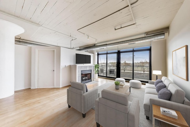1525 S Sangamon St Unit 312, Chicago, IL 60608 - living room featuring light wood finished floors, a tile fireplace, and floor to ceiling windows