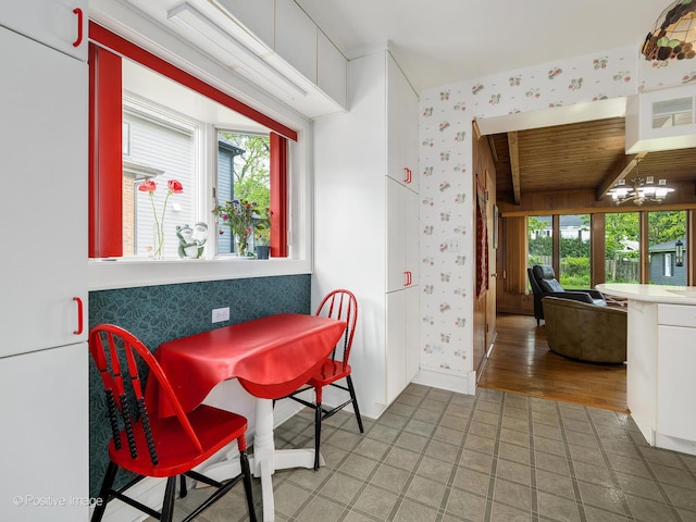 671 Euclid Ave, Glen Ellyn, IL 60137 - dining area with wallpapered walls, plenty of natural light, a chandelier, and baseboards