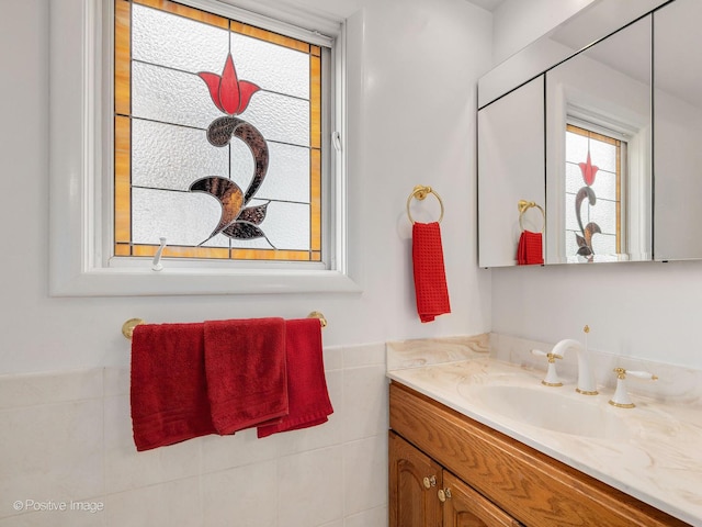 671 Euclid Ave, Glen Ellyn, IL 60137 - bathroom featuring vanity, tile walls, and a wainscoted wall