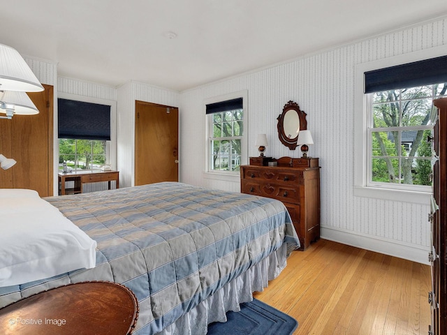 671 Euclid Ave, Glen Ellyn, IL 60137 - bedroom featuring light wood-type flooring, crown molding, wallpapered walls, baseboards, and multiple windows