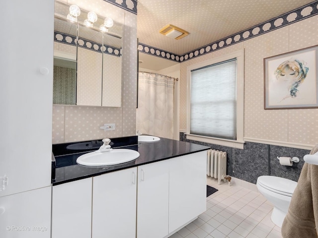 671 Euclid Ave, Glen Ellyn, IL 60137 - bathroom with wallpapered walls, radiator heating unit, tile patterned flooring, vanity, and toilet