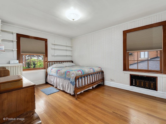 671 Euclid Ave, Glen Ellyn, IL 60137 - bedroom with light wood-style flooring, baseboards, crown molding, and a fireplace