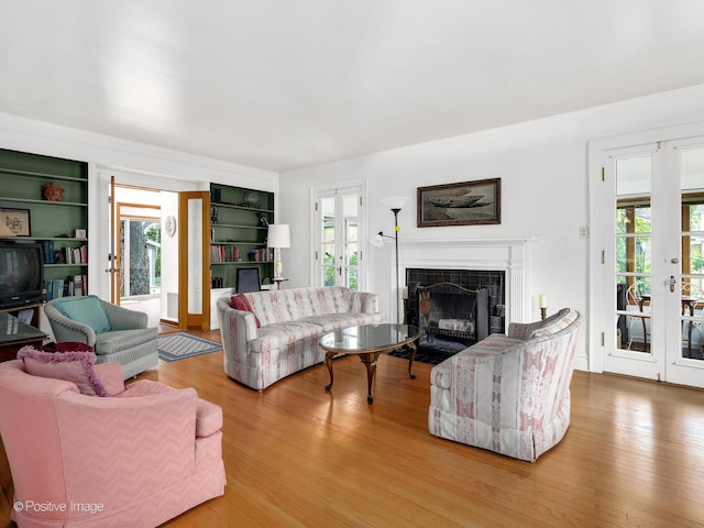 671 Euclid Ave, Glen Ellyn, IL 60137 - living room with french doors, plenty of natural light, a tiled fireplace, and crown molding