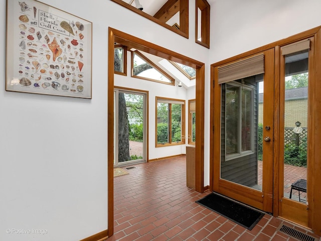 671 Euclid Ave, Glen Ellyn, IL 60137 - foyer entrance with baseboards, brick flooring, and vaulted ceiling