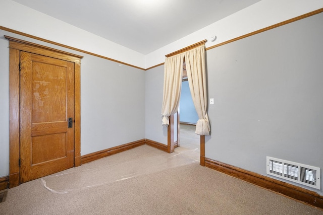 empty room with light colored carpet and baseboards