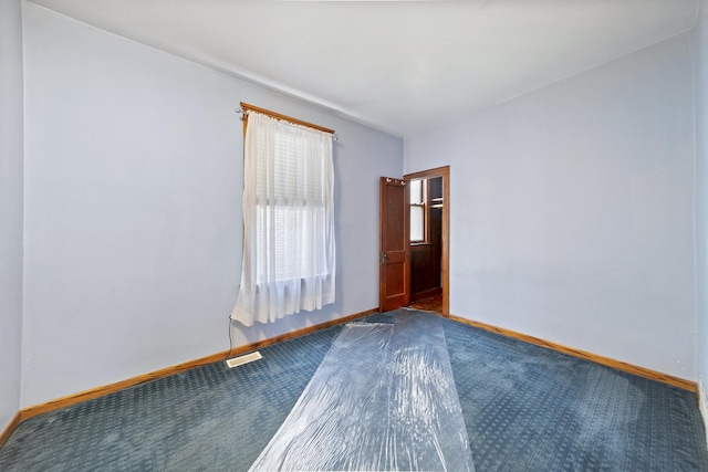empty room with baseboards and carpet floors