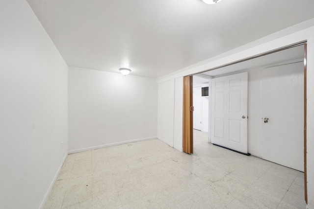 unfurnished bedroom with tile patterned floors and baseboards