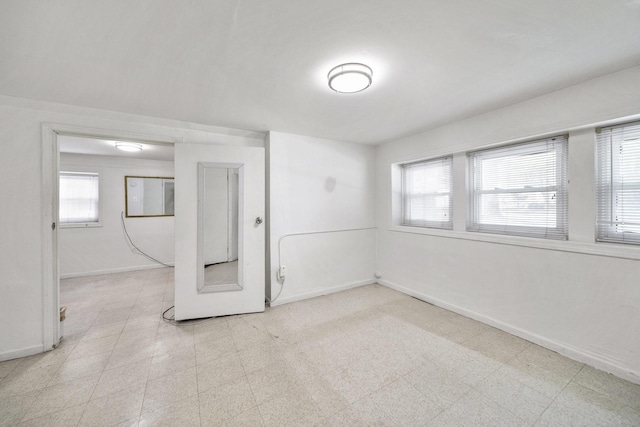 spare room featuring baseboards