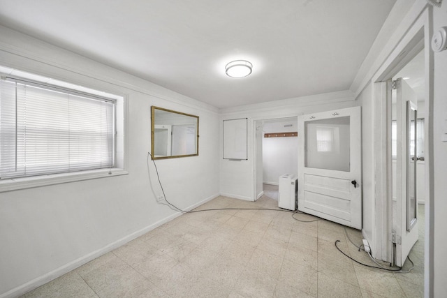 unfurnished bedroom featuring baseboards and light floors