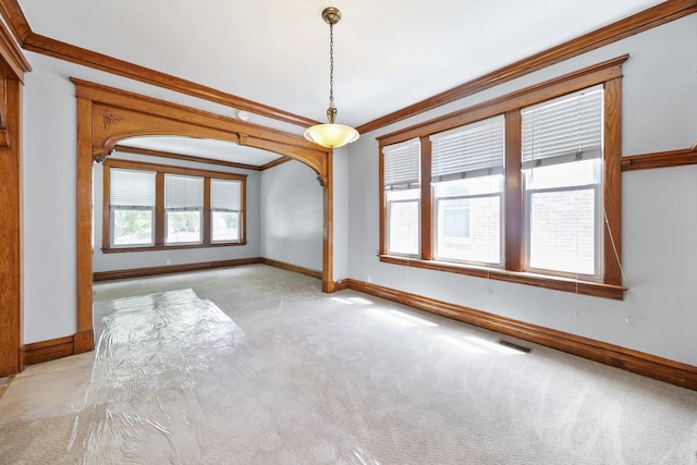 empty room with light carpet, baseboards, and ornamental molding