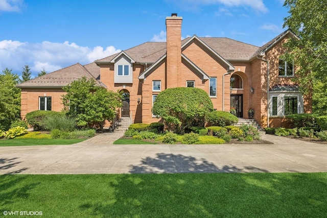 3 Shoreside Dr, South Barrington, IL 60010 - traditional-style home featuring a chimney, a front yard, and brick siding