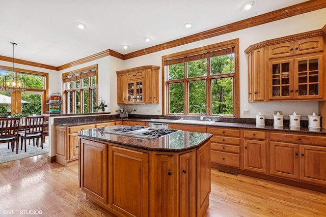 3 Shoreside Dr, South Barrington, IL 60010 - kitchen featuring stainless steel gas cooktop, glass insert cabinets, a chandelier, light wood finished floors, and ornamental molding