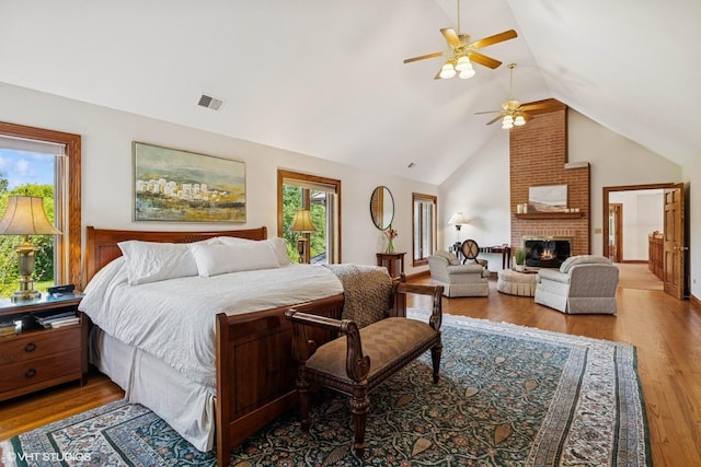 3 Shoreside Dr, South Barrington, IL 60010 - bedroom with wood finished floors, a brick fireplace, a ceiling fan, and high vaulted ceiling