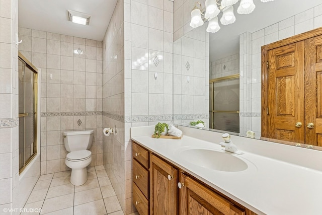3 Shoreside Dr, South Barrington, IL 60010 - bathroom with tile walls, tile patterned flooring, vanity, and bath / shower combo with glass door