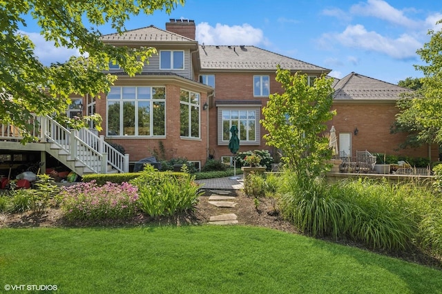 3 Shoreside Dr, South Barrington, IL 60010 - back of house with brick siding, a chimney, a lawn, and stairs