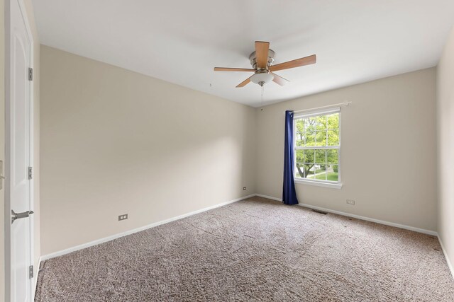 1462 Haversham Dr, Aurora, IL 60502 - spare room featuring ceiling fan, carpet flooring, and baseboards