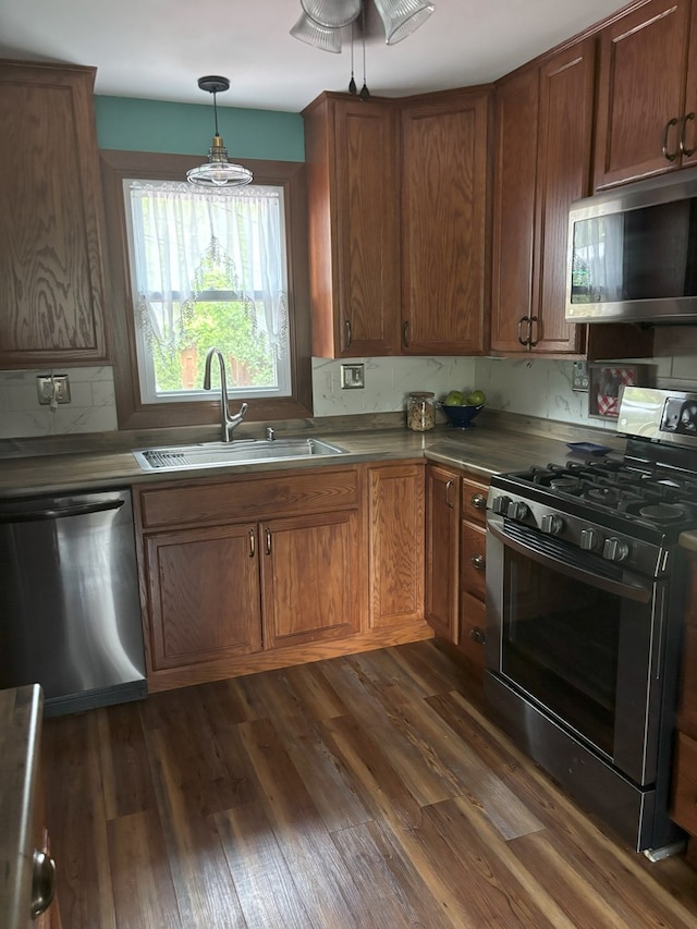 5116 154th St, Oak Forest, IL 60452 - kitchen featuring stainless steel appliances, a sink, dark wood finished floors, and brown cabinets